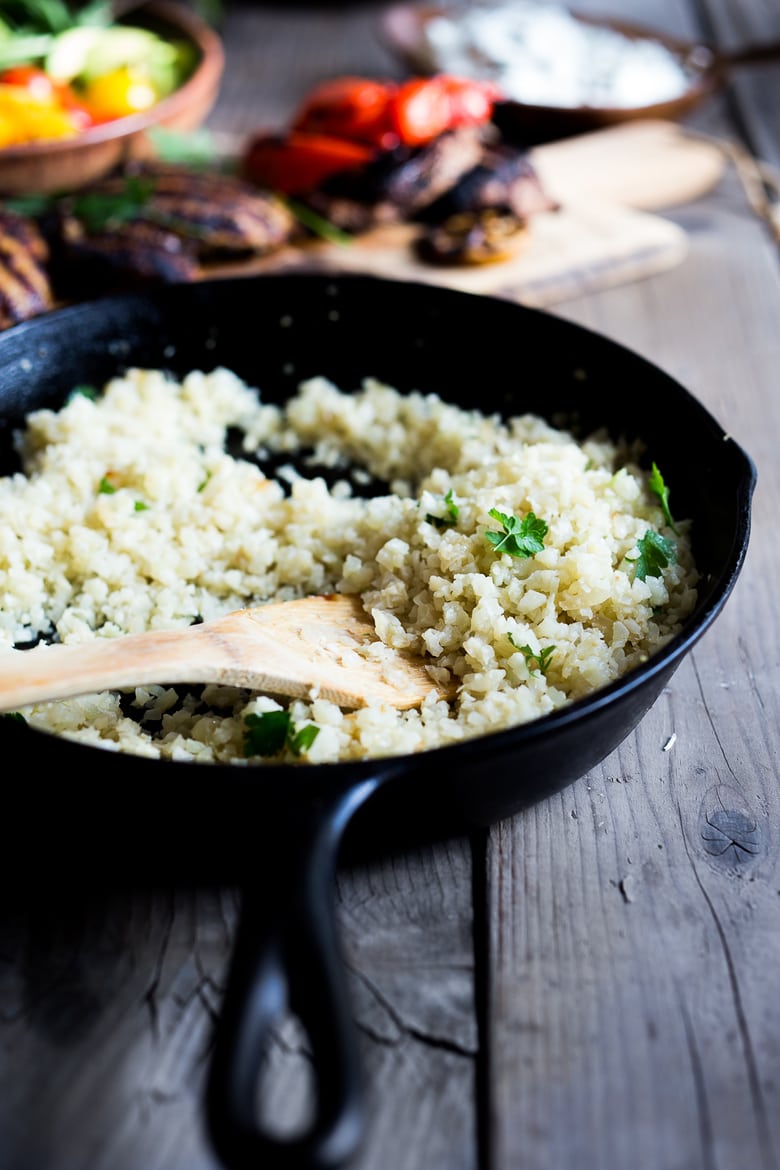 A simple tasty recipe for Grilled Greek Souvlaki Bowl with Cauliflower Rice, flavorful Cucumber Yogurt Sauce and fresh summer vegetables. This can be made with Grilled Chicken or Grilled Portobellos! | www.feastingathome.com