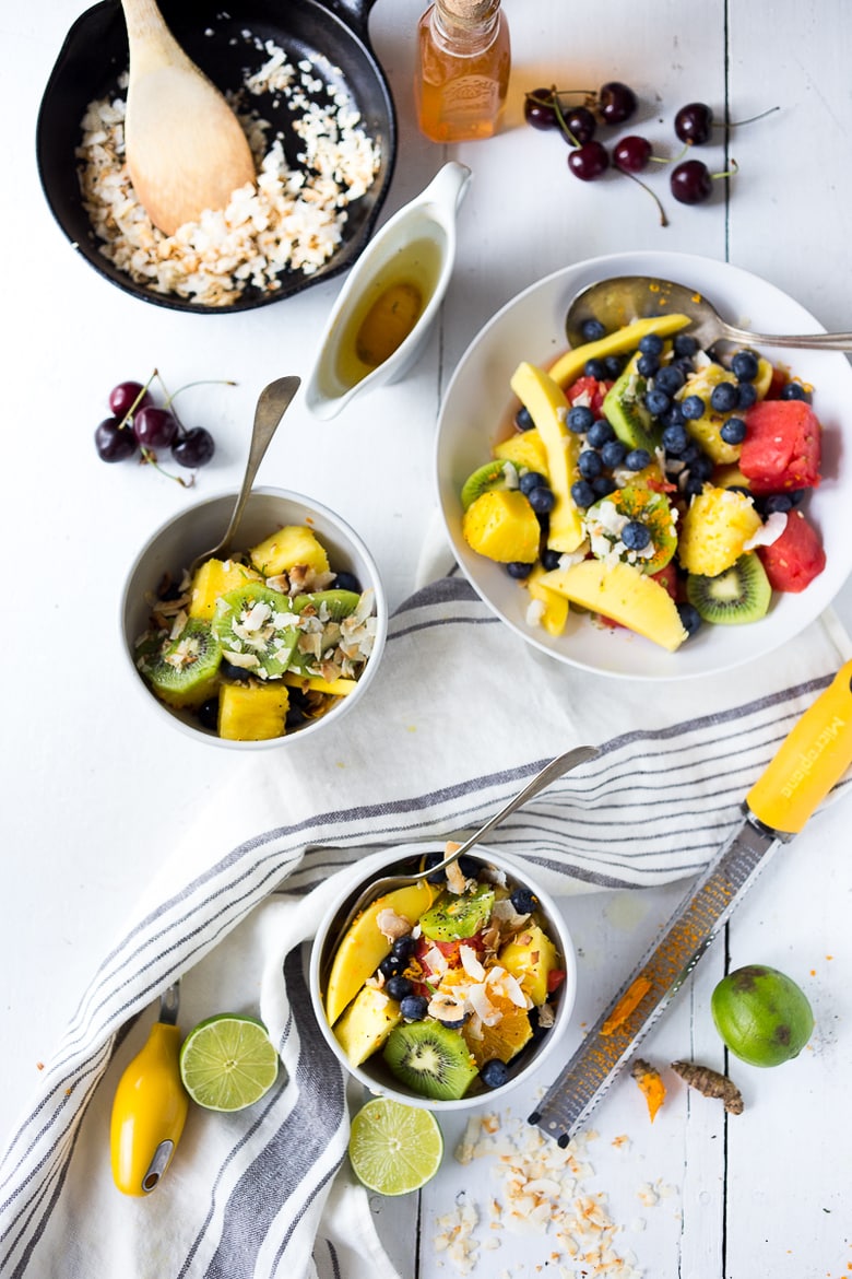 Exotic Turmeric Fruit Salad with fresh grated turmeric root, orange and lime zest and your favorite fruits, topped w/ toasted coconut flakes. Sugar free. | www.feastingathome.com