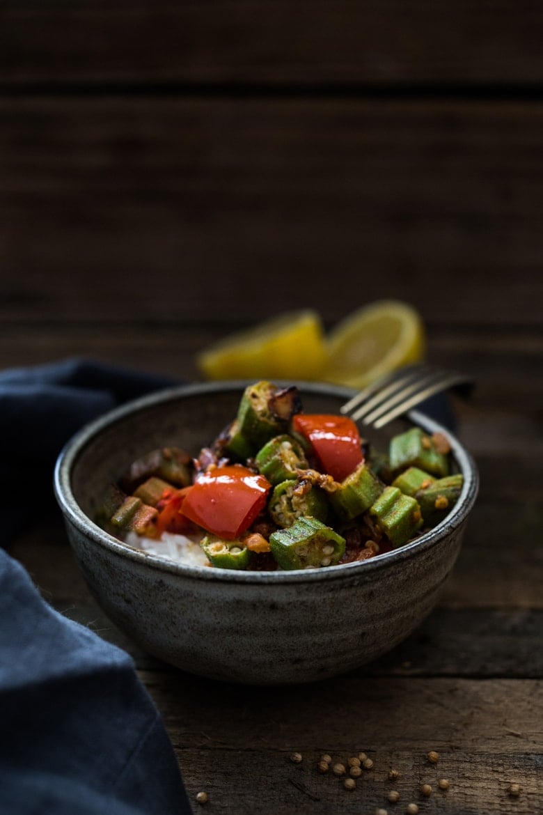 Egyptian Okra over Rice- A simple delicious vegan meal made with fresh okra, tomatoes and flavorful Middle Eastern Spices | www.feastingathome.com