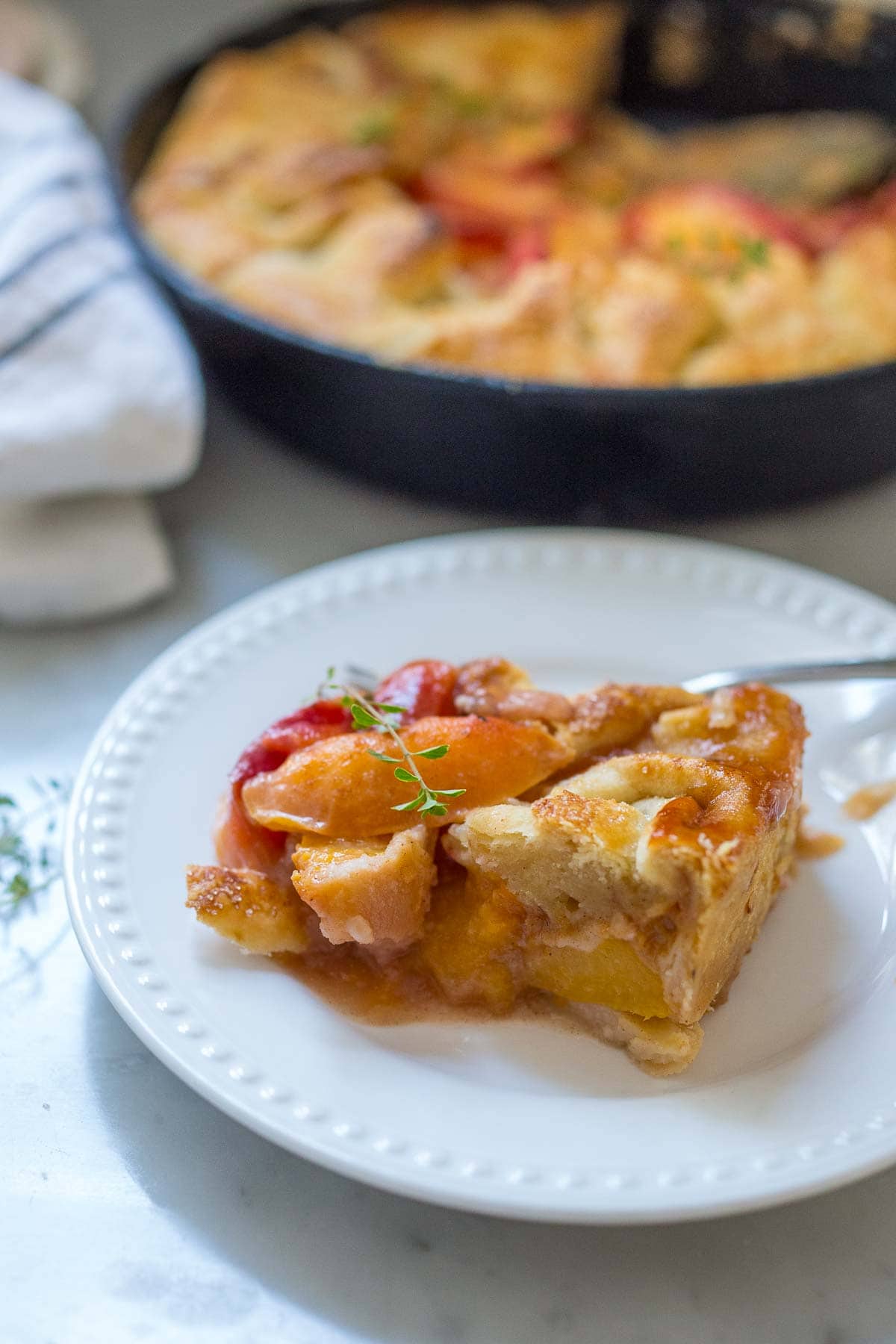 This Peach Pie recipe couldn't be any easier! It is baked in a cast-iron skillet and made with fresh summer peaches, yielding a golden, flaky crust every time. It's an irresistible dessert, perfect for summer. 