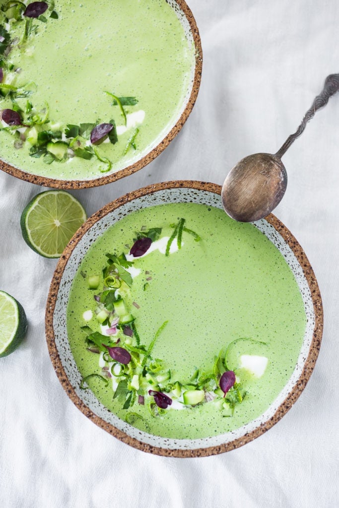 A refreshing flavorful recipe for Chilled Cucumber Soup with yogurt, cilantro, coriander and lime. Top this with shrimp or keep it vegetarian! So tasty. | www.feasingathome.com