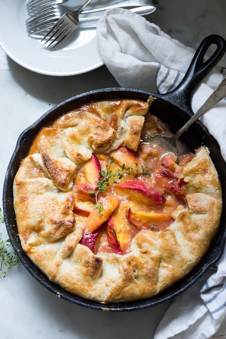 An old fashioned, Farm Style Peach Galette baked in a skillet. A simple, easy and fast recipe that comes out perfect every time! | www.feastingathome.com