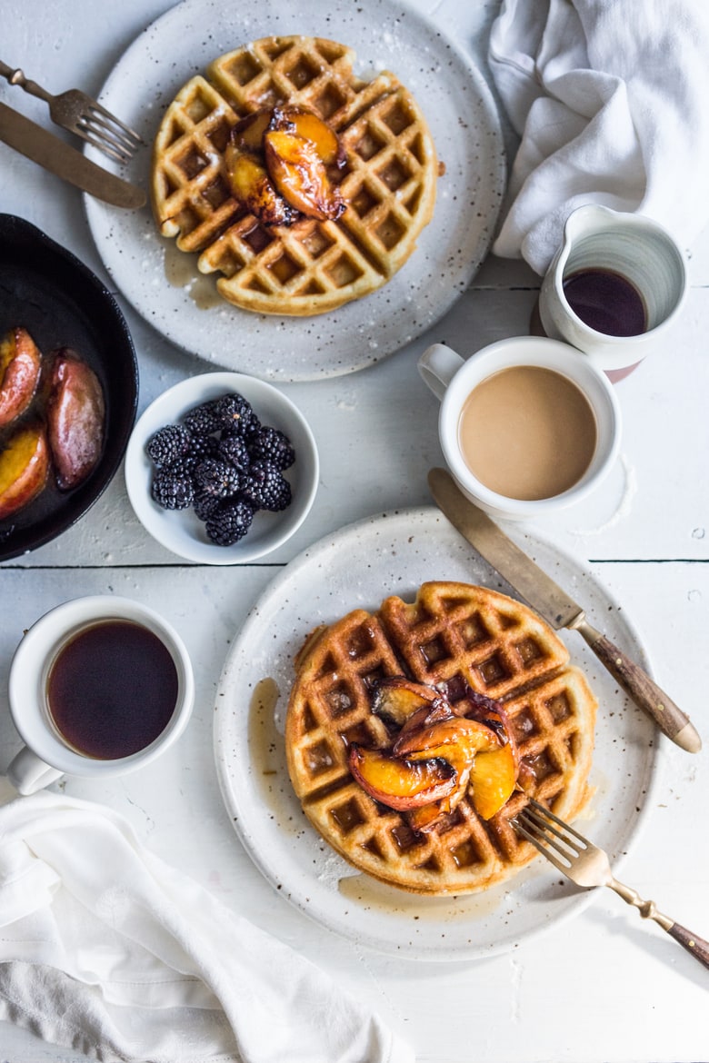 Crisp and light, Sourdough Waffles are delicious and SO simple to make using your extra starter. Top w/ Maple-glazed peaches or stone fruit.| www.feastingathome.com