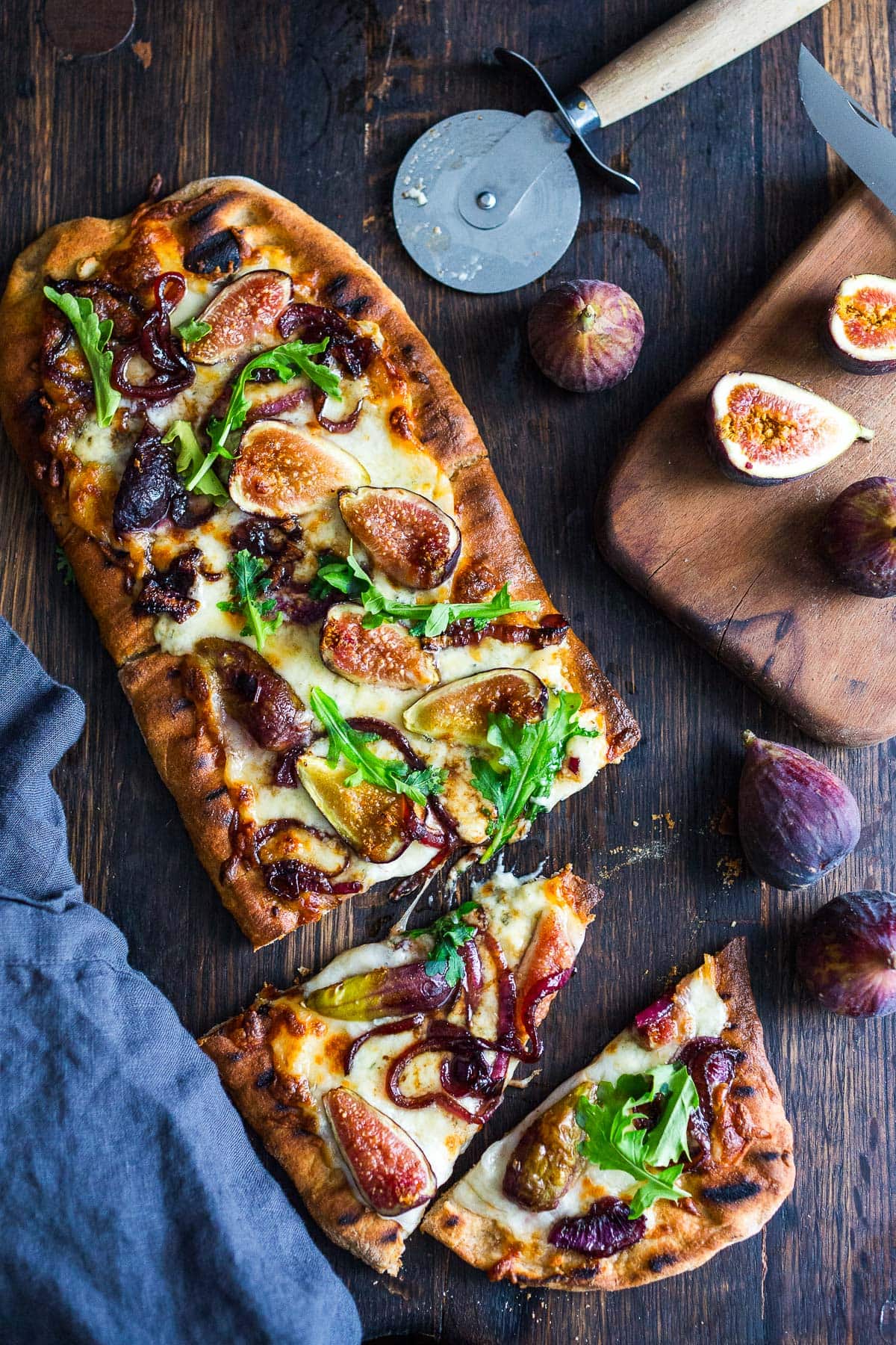 This delicious Fig Pizza with balsamic onions, creamy gorgonzola cheese, and fresh arugula is the perfect combination of flavors! Bake it or grill it, either way, you'll love this fall-inspired vegetarian pizza!