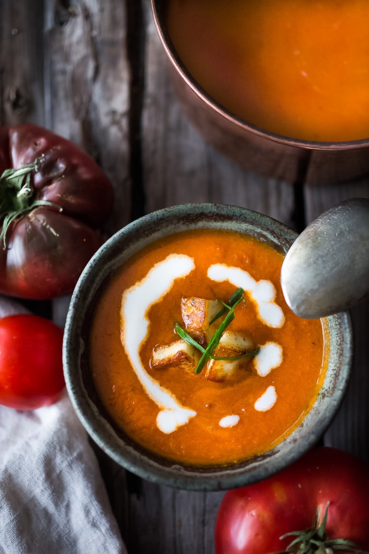 Roasted Tomato Soup with fresh roasted heirloom tomatoes, topped with crispy Haloumi Croutons. A healthy bowl of velvety goodness! | www.feastingathome.com | #tomatosoup #soup #vegetarian #haloumi #roastedtomatoes #roastedtomatosoup 