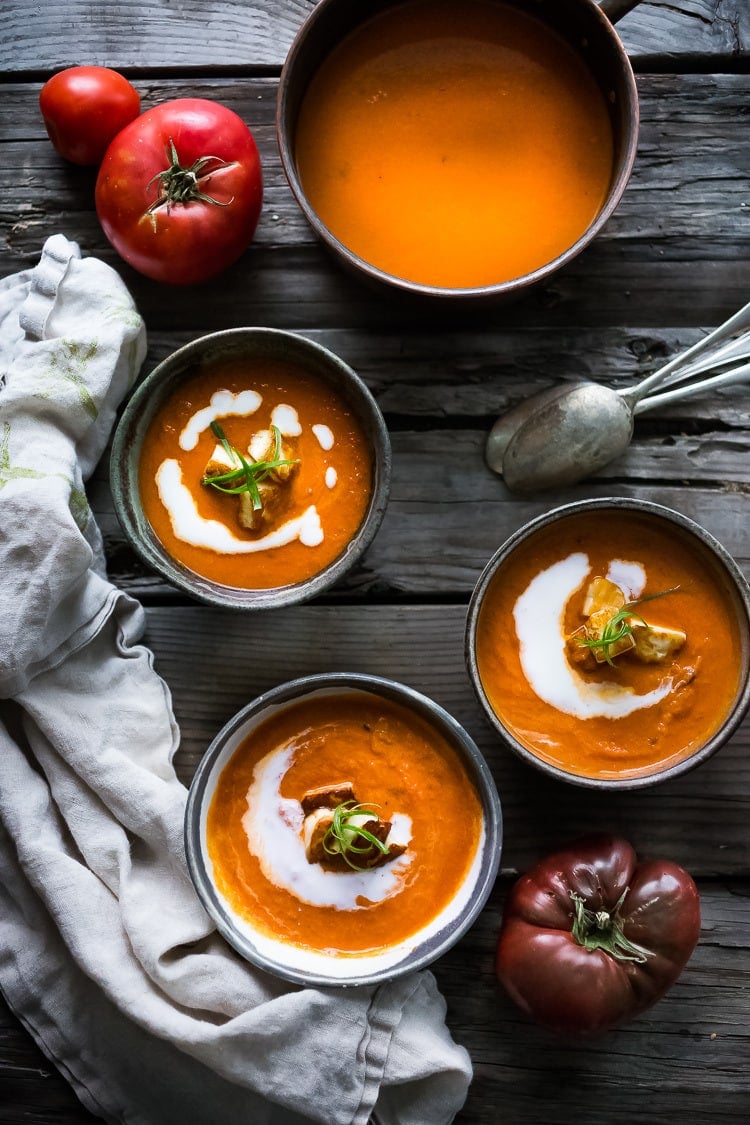 Roasted Tomato Soup with fresh roasted heirloom tomatoes, topped with crispy Haloumi Croutons. A healthy bowl of velvety goodness! | www.feastingathome.com | #tomatosoup #soup #vegetarian #haloumi #roastedtomatoes #roastedtomatosoup 