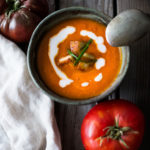 Homemade Tomato Soup with fresh roasted heirloom tomatoes, topped with crispy Haloumi Croutons. A healthy bowl of velvety goodness! | www.feastingathome.com | #tomatosoup #soup #vegetarian #haloumi #roastedtomatoes #roastedtomatosoup