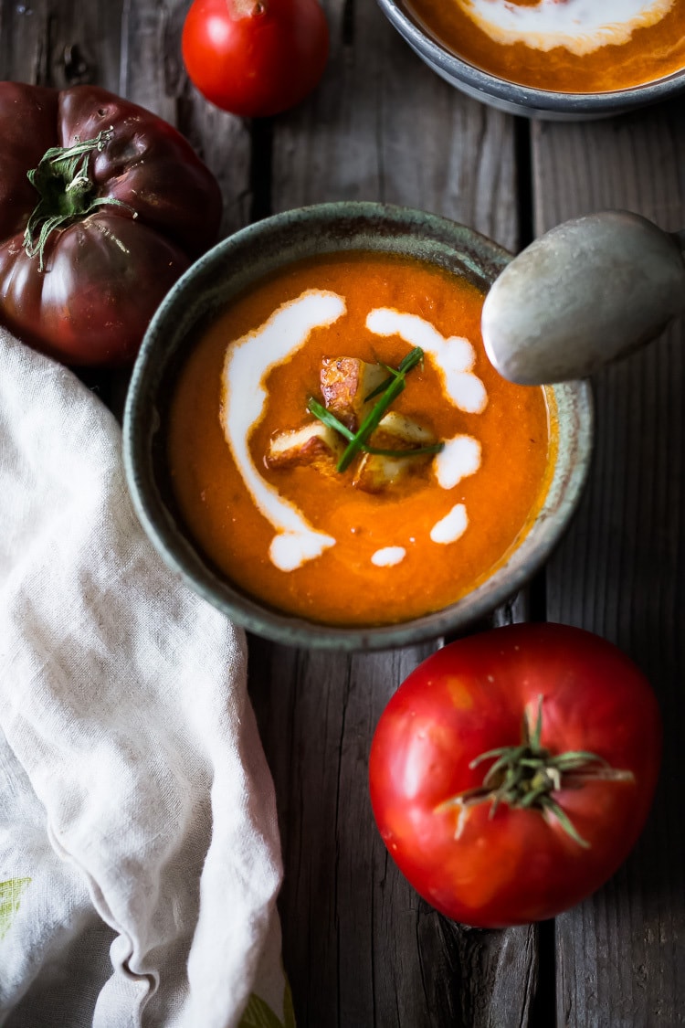 Roasted Tomato Soup with fresh roasted heirloom tomatoes, topped with crispy Haloumi Croutons. A healthy bowl of velvety goodness! | www.feastingathome.com | #tomatosoup #soup #vegetarian #haloumi #roastedtomatoes #roastedtomatosoup 