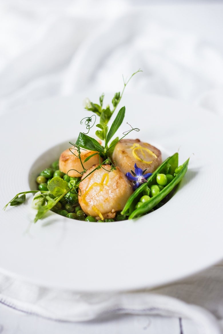 This recipe for Seared Scallops with pea sauce, tarragon, and truffle oil is a light and elegant meal, perfect for entertaining or special occasions.