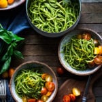 Bucatini Pasta with Arugula Pesto and Heirloom Tomatoes. A fast and flavorful weeknight dinner recipe. This Healthy pasta is Vegan! #bucatini #bucatinipasta #pastawithpesto #arugulapesto www.feastingathome.com