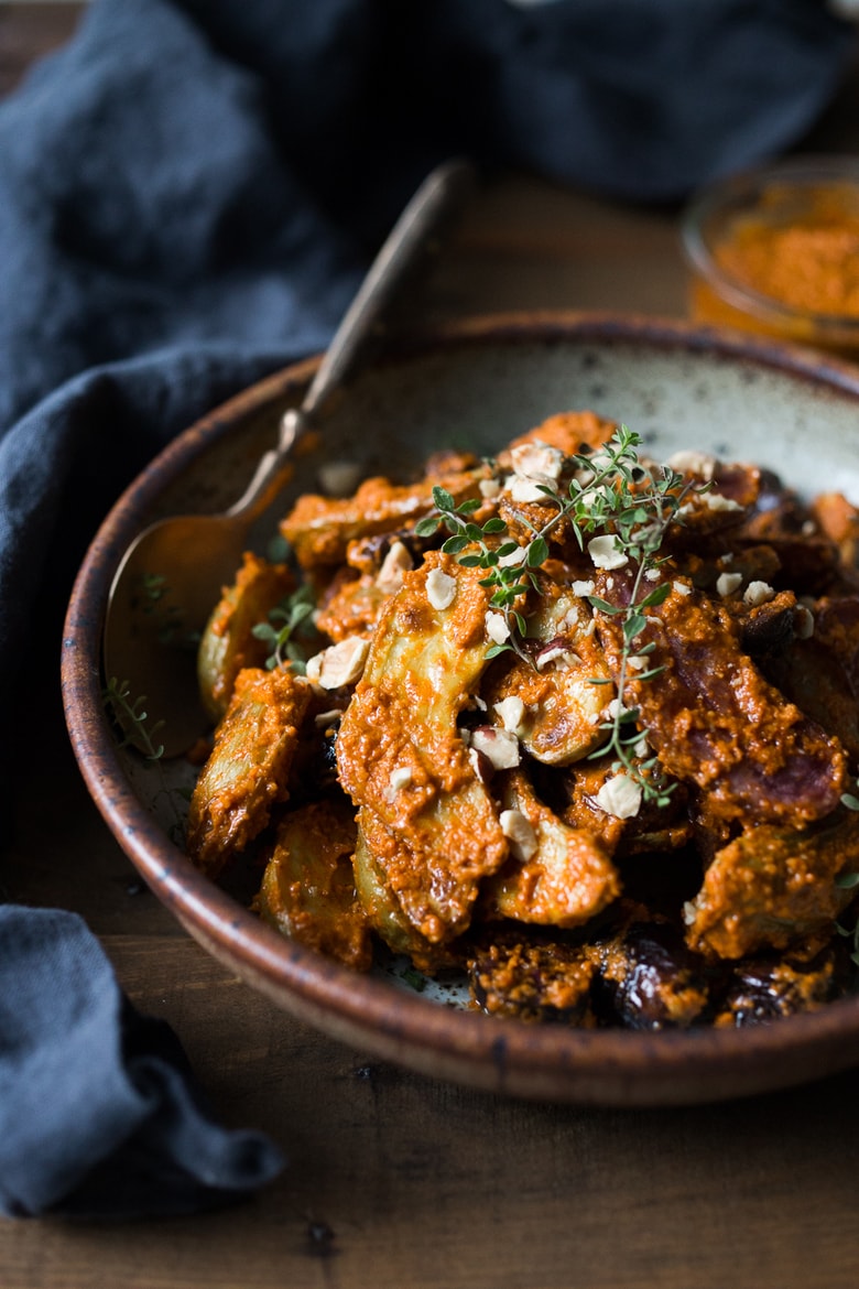 Roasted Fingerling Potatoes with Romesco Sauce, made w/ simple pantry ingredients you probably already have! A simple vegan side dish perfect for weeknight dinners or the holiday table! | www.feastingathome.com #romesco #roastedpotatoes #veganpotatoes #veganside #romescopotatoes #thanksgivingsidedish #sidedish #vegetarain 