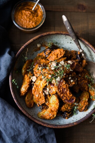 Roasted Romesco Potatoes - Roasted Fingerling Potatoes with a simple easy Romesco Sauce, made w/ simply pantry ingredients you probably already have! A simple vegan side dish perfect for weeknight dinners or the holiday table! | www.feastingathome.com #romesco #roastedpotatoes #veganpotatoes #veganside #romescopotatoes