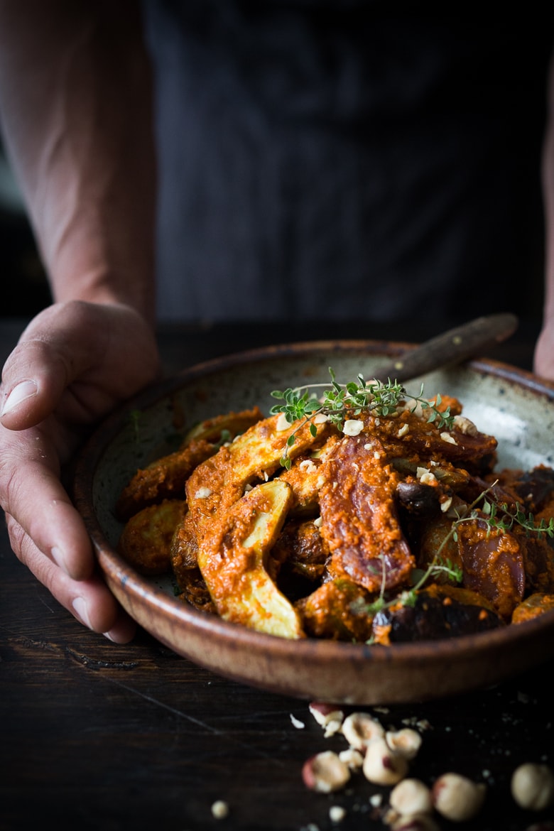 Roasted Fingerling Potatoes with Romesco Sauce, made w/ simple pantry ingredients you probably already have! A simple vegan side dish perfect for weeknight dinners or the holiday table! | www.feastingathome.com #romesco #roastedpotatoes #veganpotatoes #veganside #romescopotatoes #thanksgivingsidedish #sidedish #vegetarain 