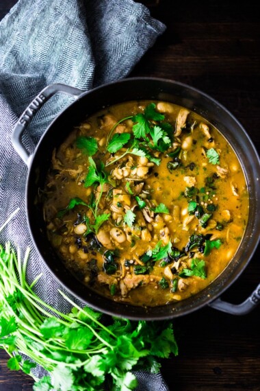 White Chicken Chili is made with with white beans, poblano chilies, cilantro, coriander and lime. Tangy, spicy, this one-pot meal is hearty and delicious! | www.feastingathome.com #whitechili #whitechickenchili #chili #chiliverde
