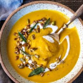 Roasted Butternut Squash Soup with Apple, Ginger and coconut and topped with toasted pumpkin seeds. This silky fall soup is full of flavor and vegan and gluten free. | #butternutsoup #butternut #vegan #fallsoup #roastedbutternutsoup www.feastingathome.com