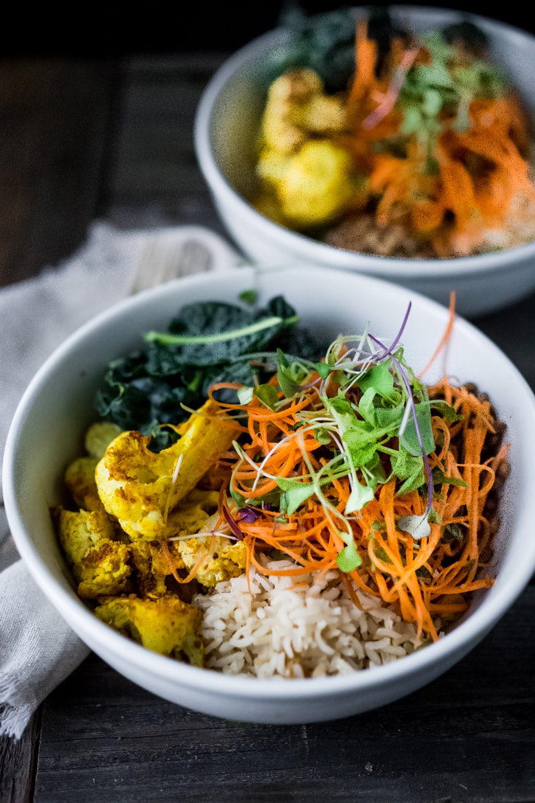 Fall Nourish Bowl- Curried cauliflower, lentils, brown rice, kale and a refreshing Carrot Slaw topped with Turmeric vinaigrette. VEGAN & Gluten-free. | www.feastingathome.com