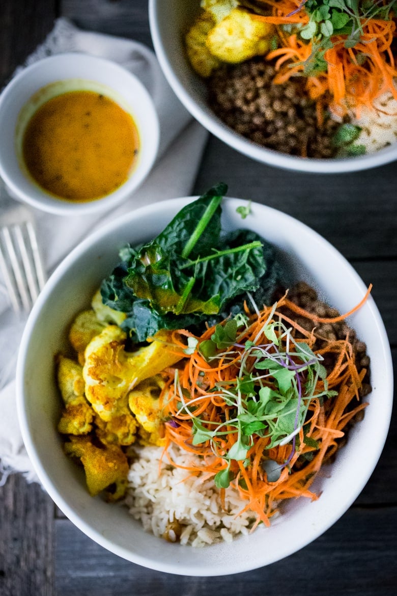 Fall Nourish Bowl- Curried cauliflower, lentils, brown rice, kale and a refreshing Carrot Slaw topped with Turmeric vinaigrette. VEGAN & Gluten-free. | www.feastingathome.com