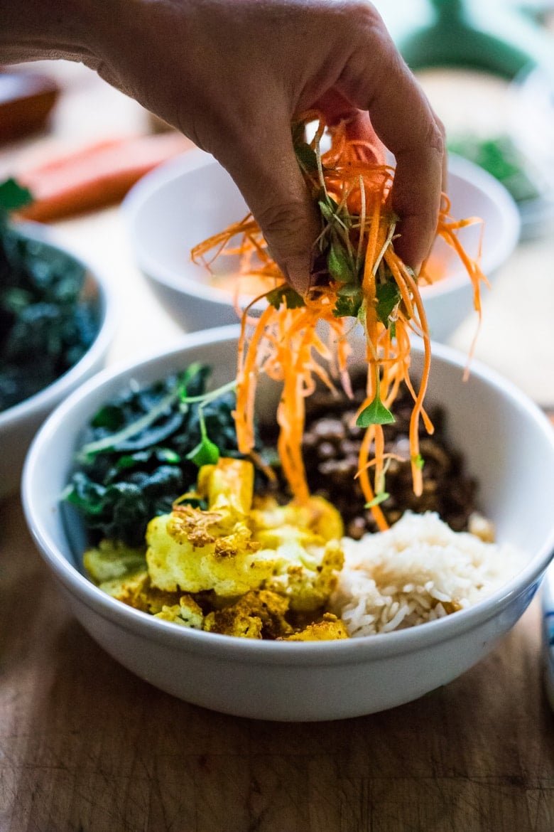 Fall Nourish Bowl- Curried cauliflower, lentils, brown rice, kale and a refreshing Carrot Slaw topped with Turmeric vinaigrette. VEGAN & Gluten-free. | www.feastingathome.com