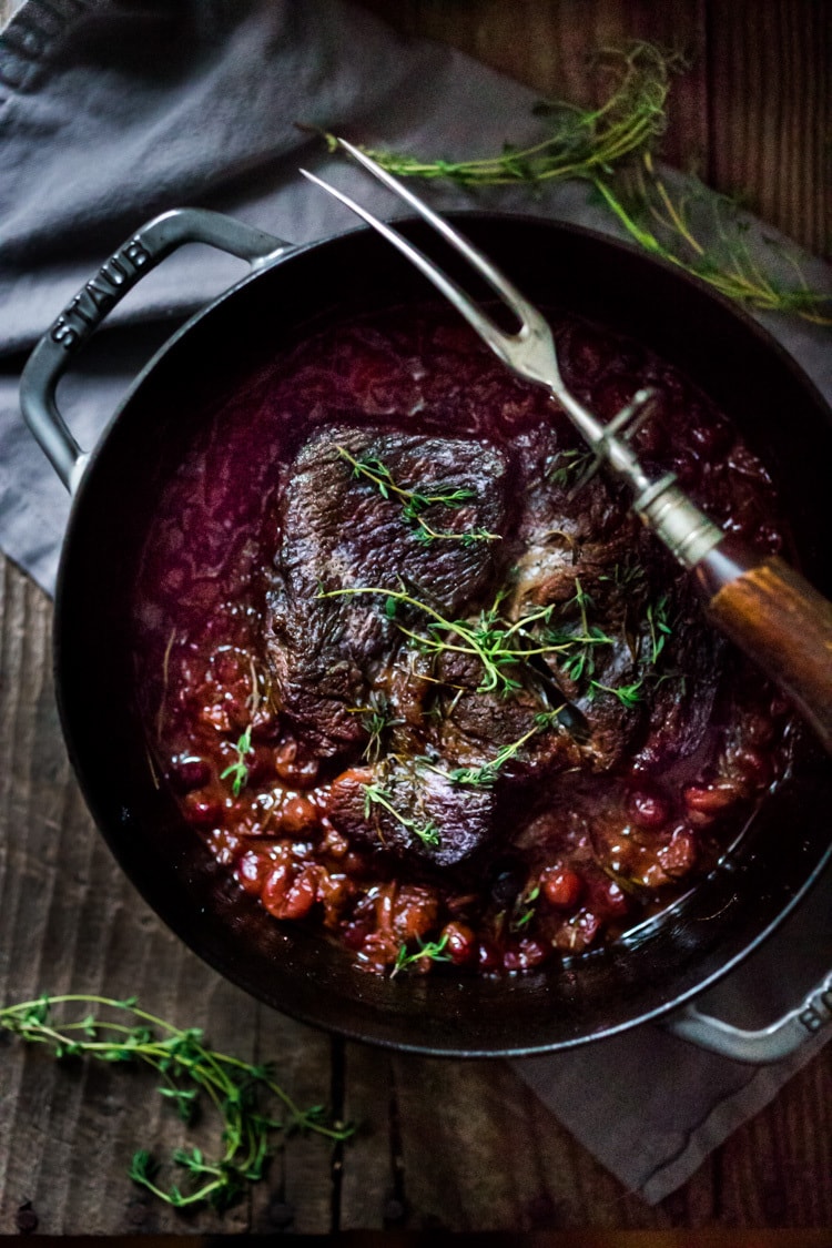 Cranberry Pot Roast - a simple festive recipe for beef roast, baked with fresh cranberries and roasted in the oven- tender, juicy and flavorful! Perfect for the holidays or a simple Sunday super.  #potroast #cranberries #cranberryrecipes #beef #beefroast #holidayrecipes #easy 