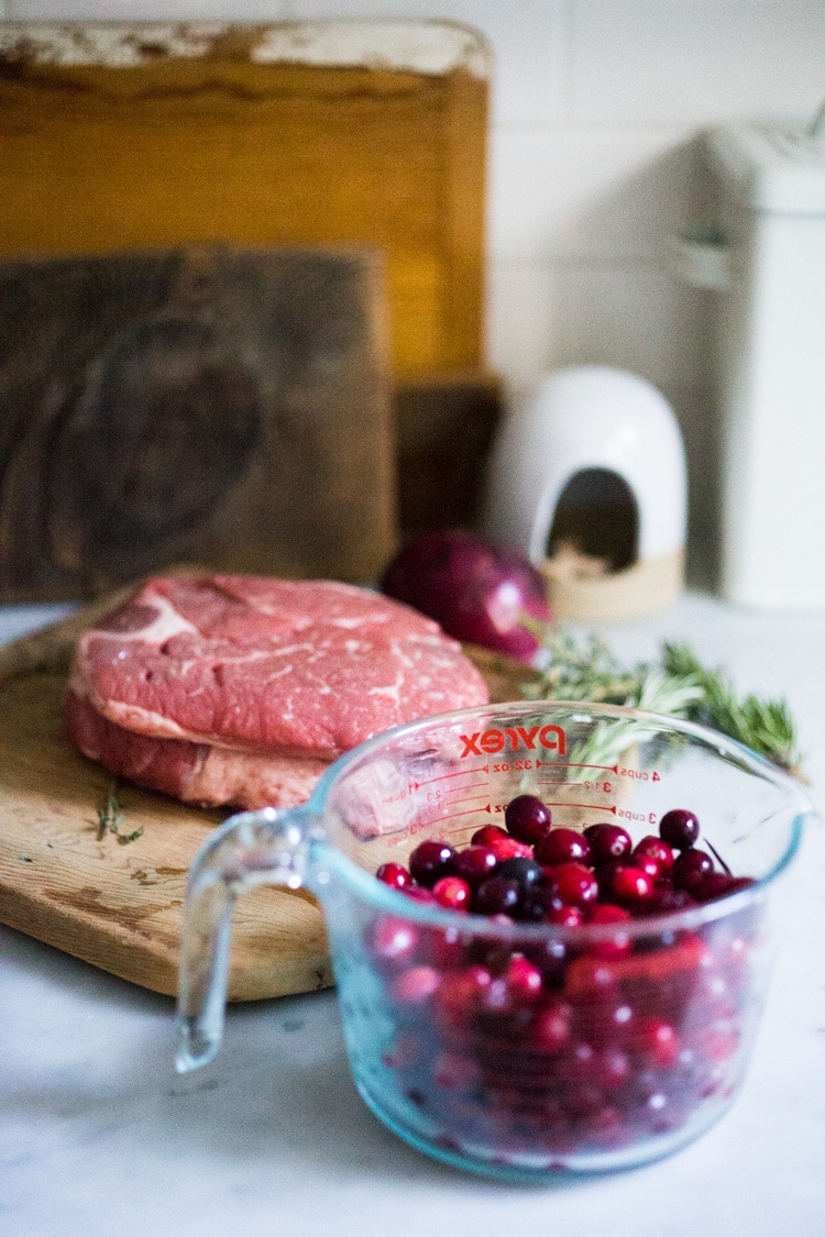 Cranberry Pot Roast - a simple festive recipe for beef roast, baked with fresh cranberries and roasted in the oven- tender, juicy and flavorful! Perfect for the holidays or a simple Sunday super.  #potroast #cranberries #cranberryrecipes #beef #beefroast #holidayrecipes #easy 