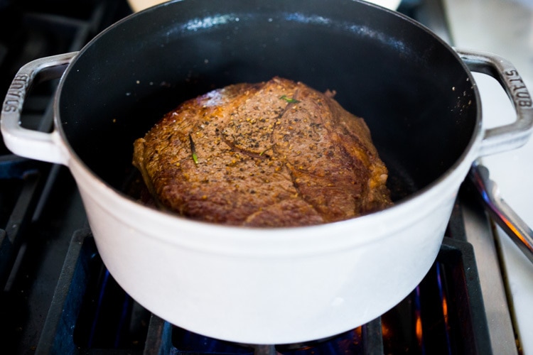 Cranberry Pot Roast - a simple festive recipe for beef roast, baked with fresh cranberries and roasted in the oven- tender, juicy and flavorful! Perfect for the holidays or a simple Sunday super. #potroast #cranberries #cranberryrecipes #beef #beefroast #holidayrecipes #easy