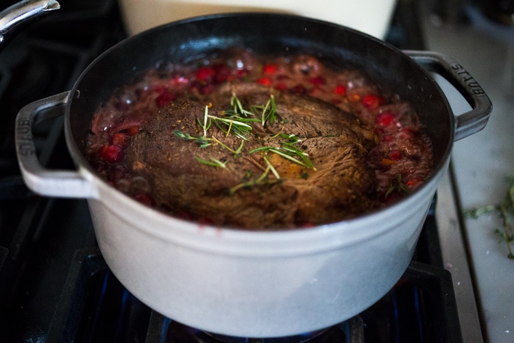 Cranberry Pot Roast - a simple festive recipe for beef roast, baked with fresh cranberries and roasted in the oven- tender, juicy and flavorful! Perfect for the holidays or a simple Sunday super. #potroast #cranberries #cranberryrecipes #beef #beefroast #holidayrecipes #easy