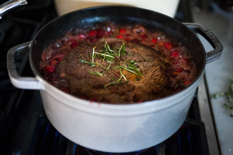 Cranberry Pot Roast - a simple festive recipe for beef roast, baked with fresh cranberries and roasted in the oven- tender, juicy and flavorful! Perfect for the holidays or a simple Sunday super.  #potroast #cranberries #cranberryrecipes #beef #beefroast #holidayrecipes #easy 