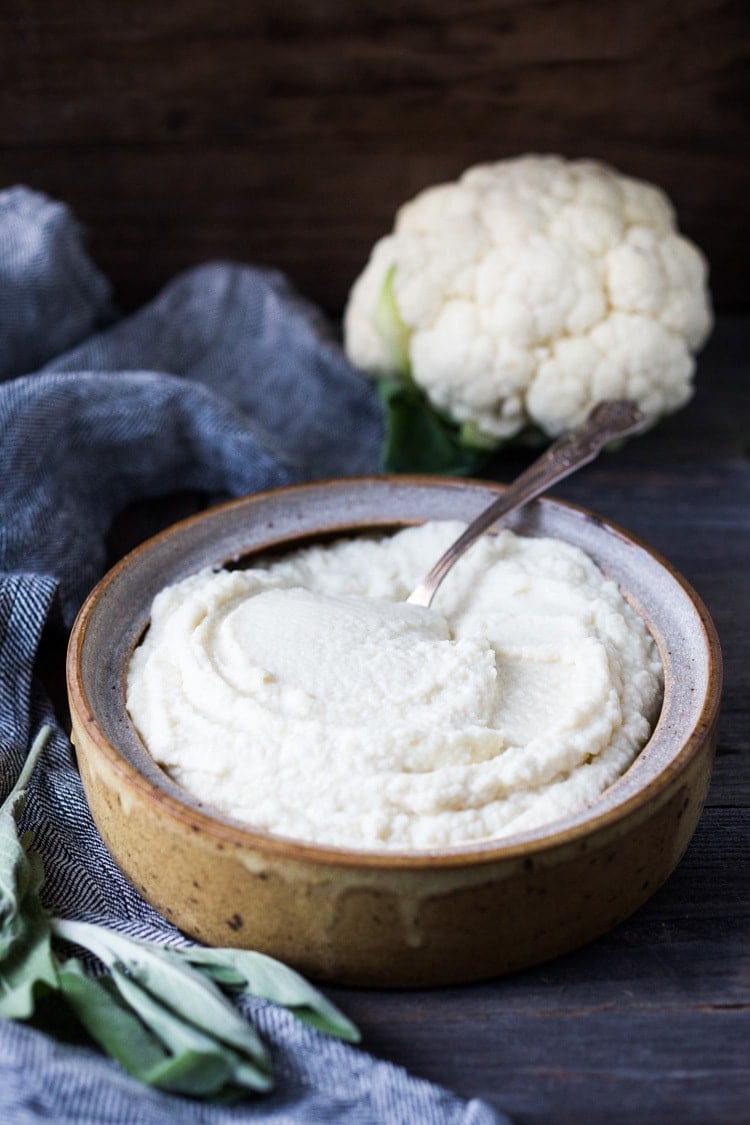 Mashed Cauliflower with Roasted Garlic, an easy delicious alternative to mashed potatoes, keto friendly, low carb, healthy and full of amazing flavor! The perfect side dish to any occasion! Vegan adaptable and gluten-free! #feastingathome #mashedcauliflower #cauliflowermashedpotatoes #cauliflowermash #vegan