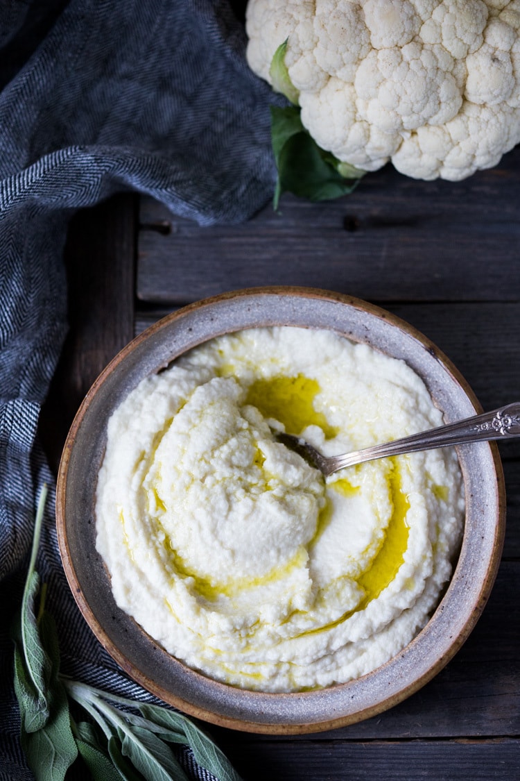 Mashed Cauliflower with Roasted Garlic, an easy delicious alternative to mashed potatoes, keto friendly, low carb, healthy and full of amazing flavor! The perfect side dish to any occasion! Vegan adaptable and gluten-free! #feastingathome #mashedcauliflower #cauliflowermashedpotatoes #cauliflowermash #vegan 