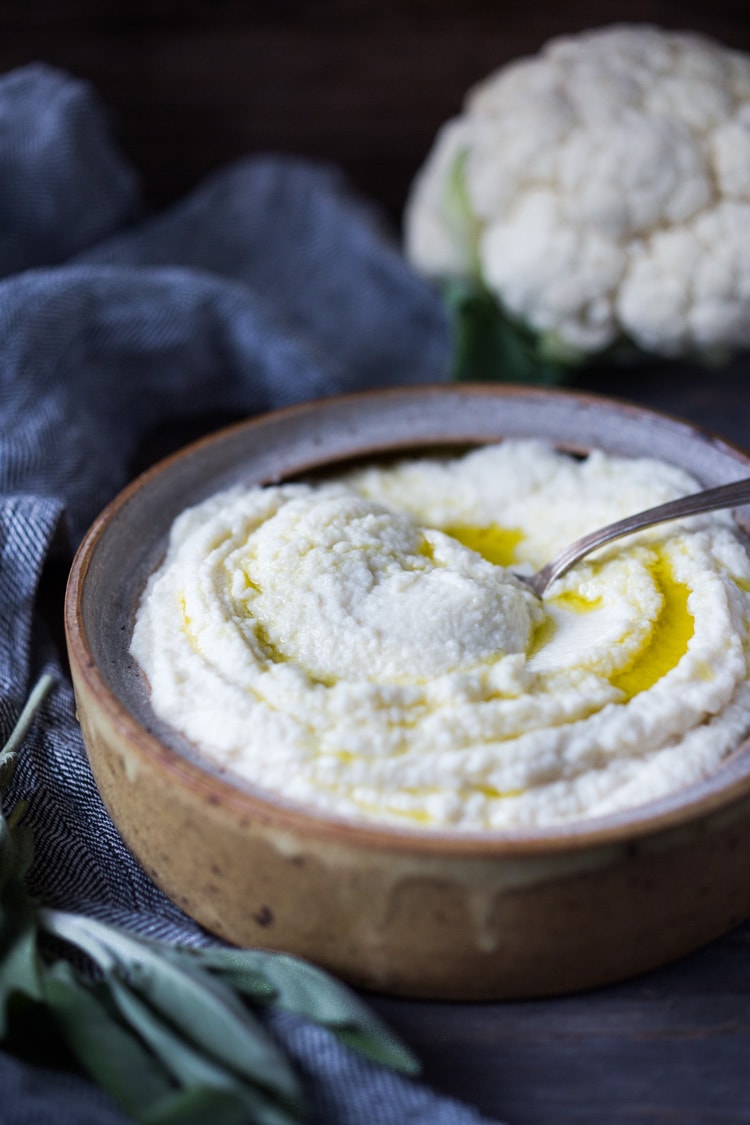 Mashed Cauliflower with Roasted Garlic, an easy delicious alternative to mashed potatoes, keto friendly, low carb, healthy and full of amazing flavor! The perfect side dish to any occasion! Vegan adaptable and gluten-free! #feastingathome #mashedcauliflower #cauliflowermashedpotatoes #cauliflowermash #vegan 