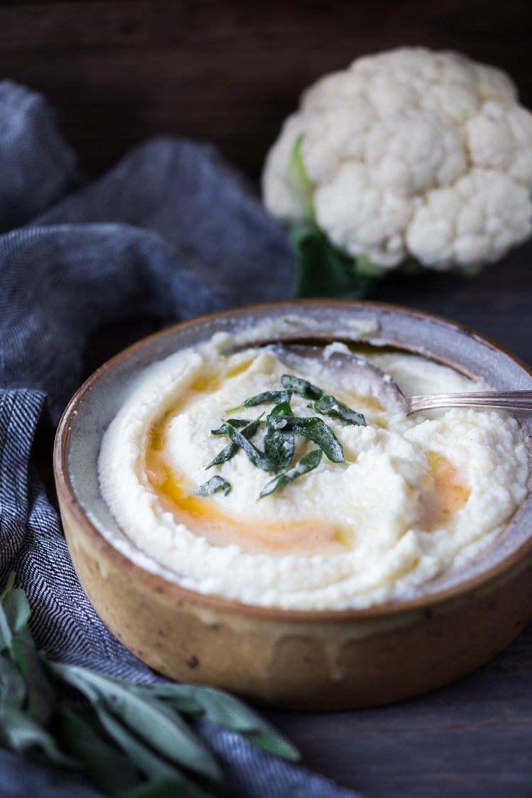 Mashed Cauliflower with Roasted Garlic, an easy delicious alternative to mashed potatoes, keto friendly, low carb, healthy and full of amazing flavor! The perfect side dish to any occasion! Vegan adaptable and gluten-free! #feastingathome #mashedcauliflower #cauliflowermashedpotatoes #cauliflowermash #vegan 