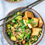 This Stir-fry Tofu, Brussels Sprouts & Mushroom Bowl with scallions and toasted sesame seeds can be made in under 20 minutes and is vegan! Tasty and easy, perfect for a quick healthy weeknight dinner.