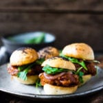 Vegan BBQ Sliders made with delicious "pulled" Spaghetti Squash, Pickled Onions and Arugula- a simple, tasty and healthy alternative to pulled pork! | #vegan #sliders #spaghettisquash #jackfruit #vegansliders #veganappetizer #bbq #appetizer #potluck |www.feastingathome.com