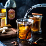 Maple Ginger Hot Toddy- made with whiskey, hot water, muddled ginger, whole spices and lemon- this winter sipper soothes a sore throat and warms the body. | www.feastingathome.com