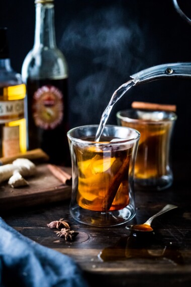 Maple Ginger Hot Toddy- made with whiskey, hot water, muddled ginger, whole spices and lemon- this winter sipper soothes a sore throat and warms the body. | www.feastingathome.com