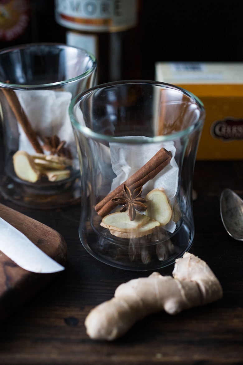 Maple Ginger Hot Toddy- made with whiskey, hot water, muddled ginger, maple or honey, whole spices and a squeeze of lemon- soothes a sore throat and warms the body. | www.feastingathome.com