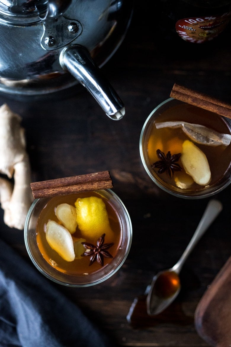 Maple Ginger Hot Toddy- made with whiskey, hot water, muddled ginger, maple or honey, whole spices and a squeeze of lemon- soothes a sore throat and warms the body. | www.feastingathome.com