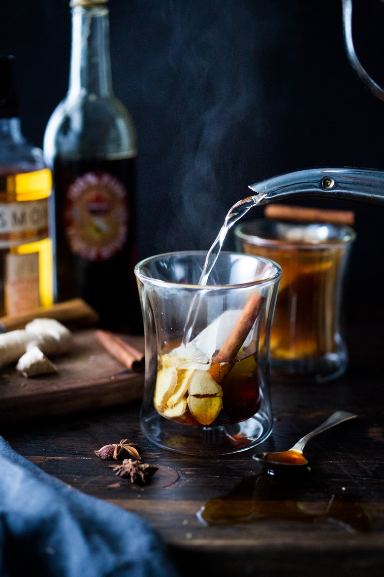 Maple Ginger Hot Toddy- made with whiskey, hot water, muddled ginger, maple or honey, whole spices and a squeeze of lemon- soothes a sore throat and warms the body. | www.feastingathome.com