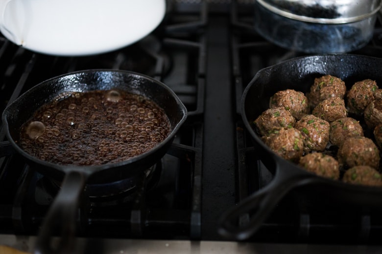 Moroccan Meatballs with Pomegranate Glaze- a festive holiday appetizer, or serve as a sumptious main dish with fluffy cous cous. | www.feastingathome.com