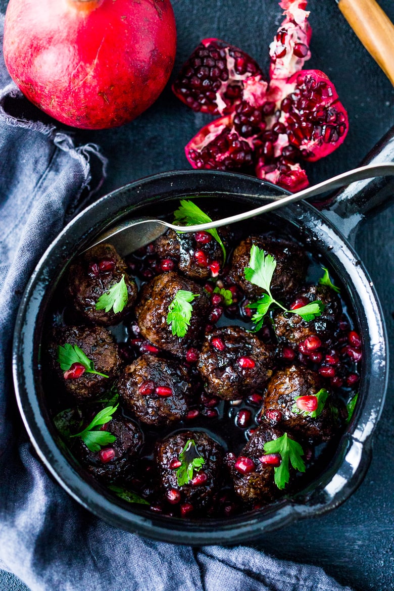 Moroccan Meatballs with Pomegranate Glaze- a festive holiday appetizer, or serve as a sumptious main dish with fluffy cous cous. | www.feastingathome.com