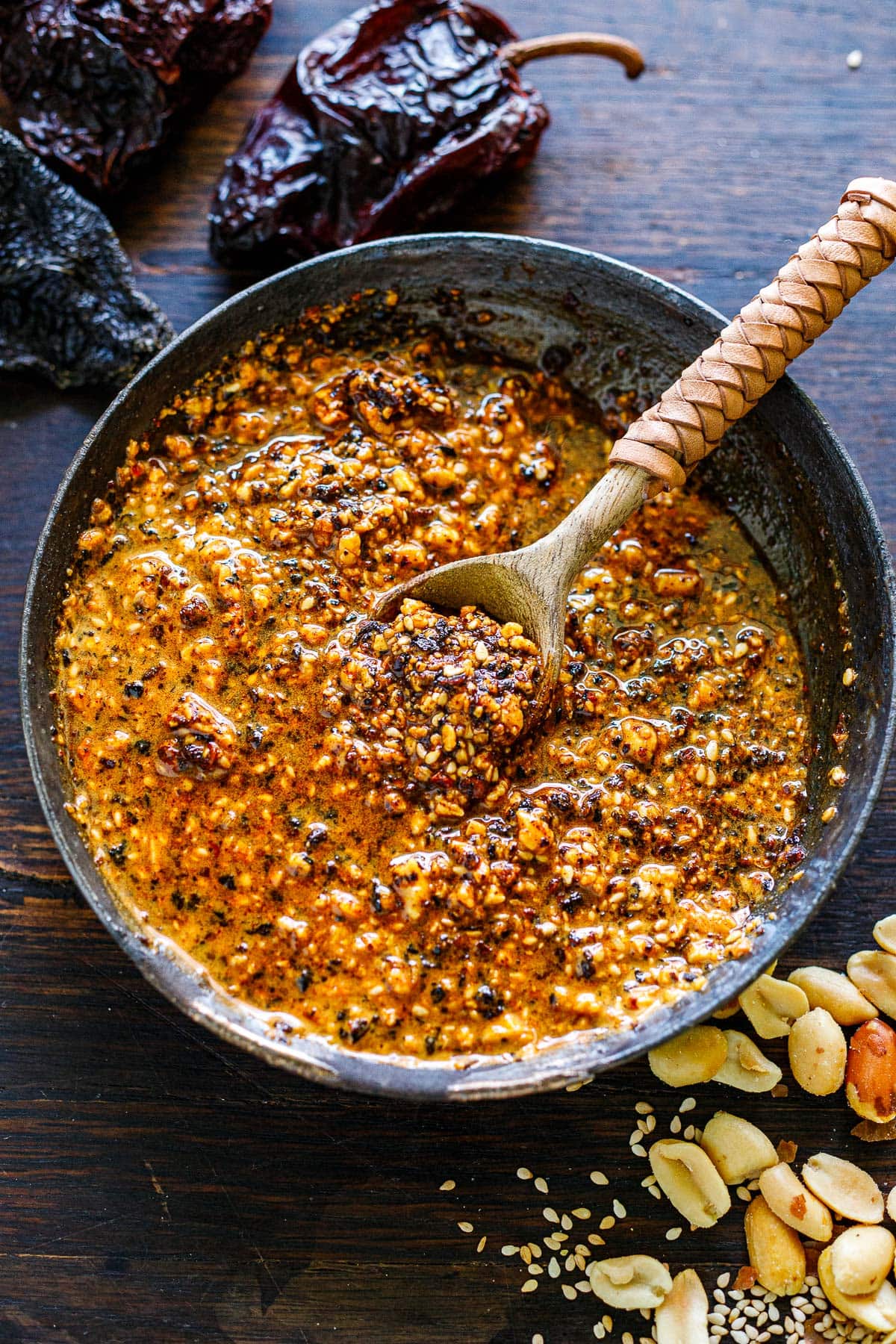 Mexican salsa macha in a bowl with a wood spoon. 