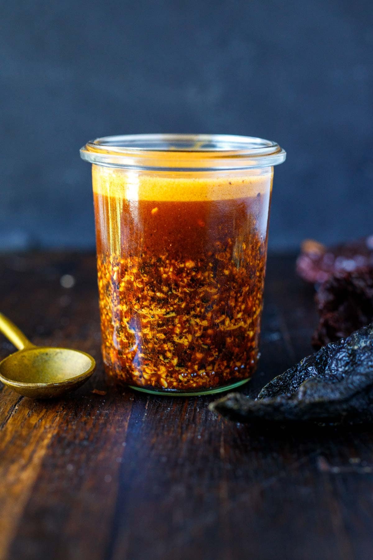 Mexican Salsa macha recipe in a small jar with a spoon. 