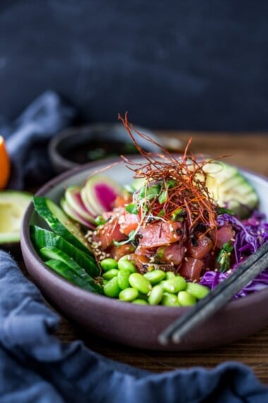 Poke Bowl- made with fish (or TOFU!) seasoned with sesame oil, over rice or keep noodles, surrounded with healthy veggies and citrus ponzu sauce! | www.feastingathome.com