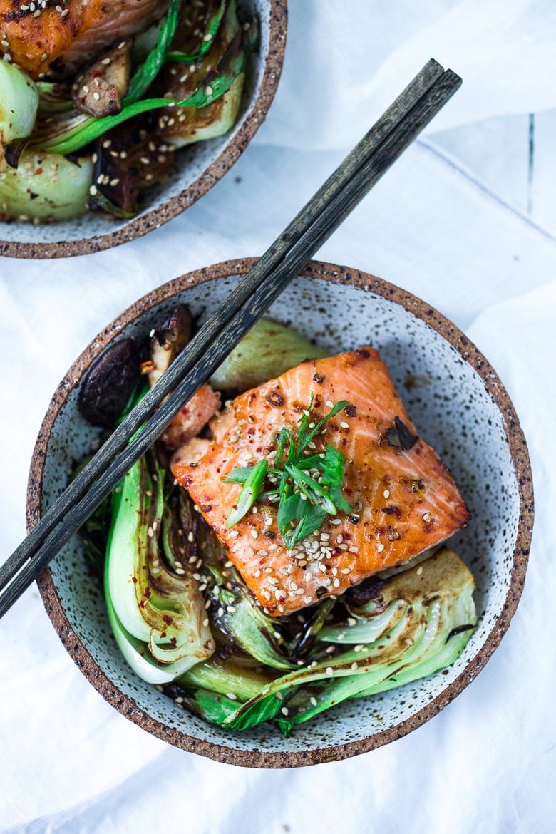 Teriyaki Salmon with Bok Choy- in a bowl with chops ticks. 