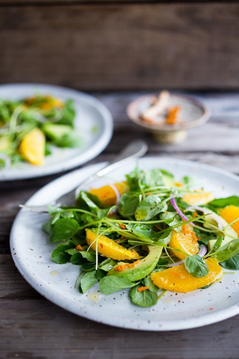 This Watercress Salad is peppery and bright, tossed in a flavorful Turmeric Vinaigrette with orange slices, avocado and red onion.