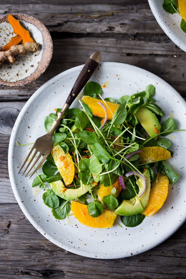 This Watercress Salad is peppery and bright, tossed in a flavorful Turmeric Vinaigrette with orange slices, avocado and red onion.