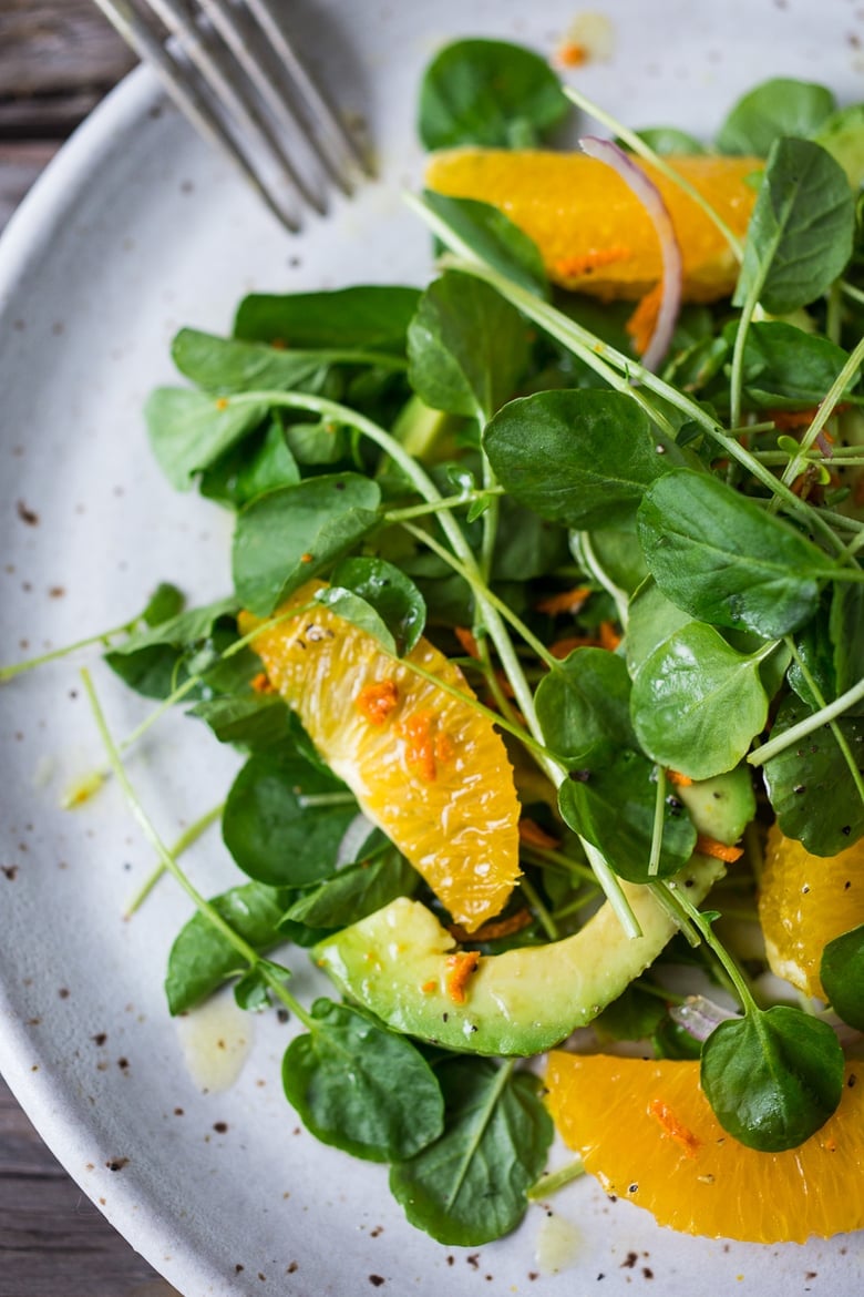 This Watercress Salad is peppery and bright, tossed in a flavorful Turmeric Vinaigrette with orange slices, avocado and red onion.