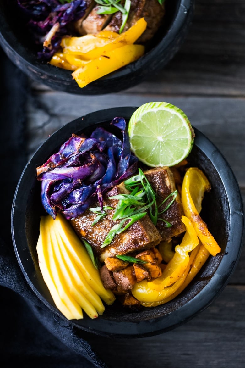 Caribbean-Style, Island Bowls- with roasted cabbage, sweet potatoes and your choice of tofu (or chicken), baked in the most flavorful Caribbean-style marinade ever!  Serve over a bed of seasoned black beans with fresh juicy mango and lime juice!  Yum! 