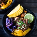 Caribbean-Style, Island Bowls- with roasted cabbage, sweet potatoes and your choice of tofu (or chicken), baked in the most flavorful Caribbean-style marinade ever!  Serve over a bed of seasoned black beans with fresh juicy mango and lime juice!  Yum! 