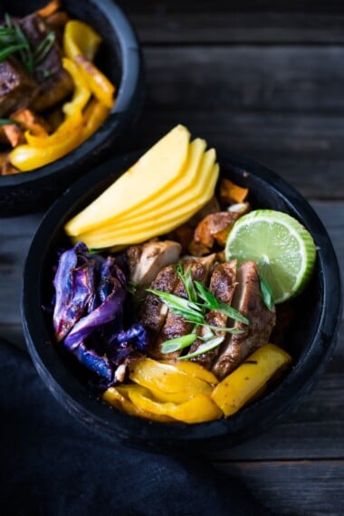 Caribbean-Style, Island Bowls- with roasted cabbage, sweet potatoes and your choice of tofu (or chicken), baked in the most flavorful Caribbean-style marinade ever!  Serve over a bed of seasoned black beans with fresh juicy mango and lime juice!  Yum! 